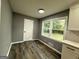 Bright dining area features wood floors, grey walls, and natural light from the double windows at 1351 John Robert Dr, Morrow, GA 30260