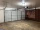 Spacious garage with white door, brick wall with ventilation, and concrete floor at 1351 John Robert Dr, Morrow, GA 30260