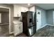 Kitchen area with white cabinets, stainless steel refrigerator, and modern finishes at 1351 John Robert Dr, Morrow, GA 30260