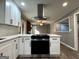 Bright kitchen with white cabinets, stainless steel appliances, and an island cooktop at 1351 John Robert Dr, Morrow, GA 30260