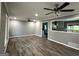 Open living room featuring wood floors, recessed lighting, and a view into the kitchen at 1351 John Robert Dr, Morrow, GA 30260