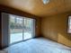 Bright room featuring a sliding glass door to the backyard and neutral tile flooring at 1351 John Robert Dr, Morrow, GA 30260