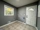 Mud room with neutral tile flooring, window with natural light, and access to the backyard at 1351 John Robert Dr, Morrow, GA 30260