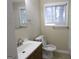 Well-lit bathroom featuring a sink with a wooden vanity and a toilet at 3037 San Juan Dr, Decatur, GA 30032