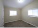 Neutral bedroom with two windows, carpeted floors, and a closet door at 3037 San Juan Dr, Decatur, GA 30032
