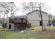 Exterior of a multi-level home with a wooden deck overlooking a green lawn at 756 Sugar Hill Ln, Conyers, GA 30094