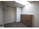 Basement features a built-in storage cabinet and brick accent wall, offering style and functionality at 756 Sugar Hill Ln, Conyers, GA 30094