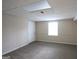 Unfinished basement area with neutral carpet, white walls, and door to exterior at 756 Sugar Hill Ln, Conyers, GA 30094