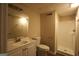 Bathroom features single sink vanity, mirror, toilet and a stand-up shower at 756 Sugar Hill Ln, Conyers, GA 30094