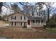 Charming split-level home with a cozy front porch, brick accents, and a red front door at 756 Sugar Hill Ln, Conyers, GA 30094