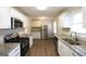 Updated kitchen with stainless steel appliances, granite countertops, and white cabinets at 756 Sugar Hill Ln, Conyers, GA 30094
