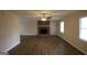 Spacious living room featuring new flooring, a brick fireplace, and abundant natural light at 756 Sugar Hill Ln, Conyers, GA 30094