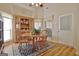 Dining room with a wooden table, chairs, and hutch, and three windows with blinds at 170 Habersham Dr, Fayetteville, GA 30214