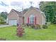 Charming brick home featuring a well-manicured lawn, two car garage, and inviting front porch at 170 Habersham Dr, Fayetteville, GA 30214