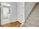 Hallway with hardwood floors leads to carpeted stairs and laundry room at 315 Antebellum Way, Fayetteville, GA 30215