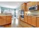 Bright eat-in kitchen features stainless steel appliances, light wood cabinets, and hardwood floors at 315 Antebellum Way, Fayetteville, GA 30215