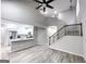 Open living space featuring modern vinyl floors, stairs, and a combined kitchen space at 102 Neal Ave, Stockbridge, GA 30281