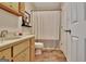 Cozy bathroom featuring a vanity with blonde wood cabinets and a shower tub combination at 676 Mcbride Rd, Fayetteville, GA 30215