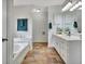Spacious bathroom showcasing tub, tiled floor, and vanity offering style and comfort at 676 Mcbride Rd, Fayetteville, GA 30215