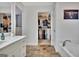 Spacious bathroom featuring a vanity, tub, and walk-in closet, offering ample storage at 676 Mcbride Rd, Fayetteville, GA 30215