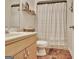 Stylish bathroom featuring a modern vanity and shower with a decorative curtain and shelf at 676 Mcbride Rd, Fayetteville, GA 30215