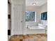 Bathroom with tub, patterned tile floor, unique window decor, and ample space at 676 Mcbride Rd, Fayetteville, GA 30215