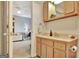 Bathroom featuring a vanity with blonde wood cabinets and is next to the room with an office space at 676 Mcbride Rd, Fayetteville, GA 30215