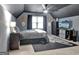 Bedroom featuring a window with natural light, a ceiling fan, and TV with cowboy decor at 676 Mcbride Rd, Fayetteville, GA 30215