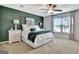 Bedroom with a king bed, green accent wall, a ceiling fan and natural light at 676 Mcbride Rd, Fayetteville, GA 30215