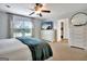 Bedroom with carpet, ceiling fan, dresser, window and a door leading to bath at 676 Mcbride Rd, Fayetteville, GA 30215