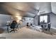 Spacious bonus room with a ceiling fan, a desk, and a comfortable seating area at 676 Mcbride Rd, Fayetteville, GA 30215