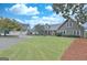 Charming, two-story home featuring a stone facade, well-manicured lawn, and convenient circular driveway at 676 Mcbride Rd, Fayetteville, GA 30215