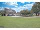 Exterior view of a home with an oversized three-car garage, circular driveway, and extensive front lawn at 676 Mcbride Rd, Fayetteville, GA 30215