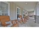 Comfortable rocking chairs line the expansive front porch, ideal for relaxation at 676 Mcbride Rd, Fayetteville, GA 30215