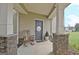 Charming front porch with stone accents, a wooden rocking chair, and a welcoming entrance at 676 Mcbride Rd, Fayetteville, GA 30215