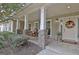 Charming front porch features rocking chairs and stacked stone columns for a cozy welcome at 676 Mcbride Rd, Fayetteville, GA 30215