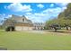 Spacious three-car garage with ample driveway space and a well-maintained lawn, perfect for car enthusiasts at 676 Mcbride Rd, Fayetteville, GA 30215