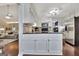 Well-lit kitchen featuring white cabinets, tile backsplash, and stainless steel appliances at 676 Mcbride Rd, Fayetteville, GA 30215