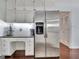 Bright kitchen featuring white cabinetry, stainless steel refrigerator, and a built-in workstation at 676 Mcbride Rd, Fayetteville, GA 30215