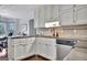 Well-lit kitchen features granite counters and white cabinetry at 676 Mcbride Rd, Fayetteville, GA 30215