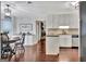 Eat-in kitchen boasts white cabinetry, granite countertops, and a view into the living room at 676 Mcbride Rd, Fayetteville, GA 30215