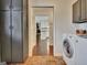 Convenient laundry room adjacent to the kitchen area featuring modern washer, dryer, and ample cabinet space at 676 Mcbride Rd, Fayetteville, GA 30215