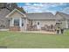 Cozy back patio with outdoor dining table and seating; perfect for entertaining at 676 Mcbride Rd, Fayetteville, GA 30215
