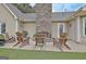 Outdoor stone fireplace with cozy chairs; perfect space for relaxing outdoors at 676 Mcbride Rd, Fayetteville, GA 30215
