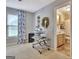 Comfortable room featuring neutral carpet, paint, with craft area, and adjacent access to a full bathroom at 676 Mcbride Rd, Fayetteville, GA 30215