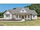 Charming home featuring a covered front porch with beautiful wooden columns and manicured landscaping at 4080 Whitney Rd, Social Circle, GA 30025