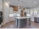 Bright, open kitchen with white cabinets, center island, and stainless steel appliances at 4080 Whitney Rd, Social Circle, GA 30025
