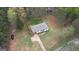Aerial view of a quaint home nestled among mature trees with a large yard and long driveway at 1910 Reese Rd, Rutledge, GA 30663