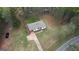 An aerial view showing the layout of the property, trees and paved driveway at 1910 Reese Rd, Rutledge, GA 30663