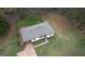 A full aerial shot of the house showing the roof, landscaping and mature trees at 1910 Reese Rd, Rutledge, GA 30663